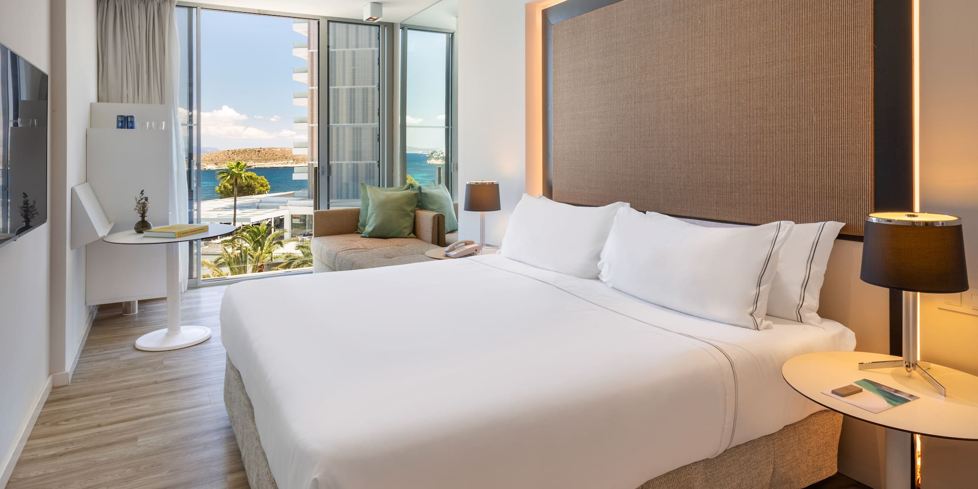 a room with a bed and a table and chairs