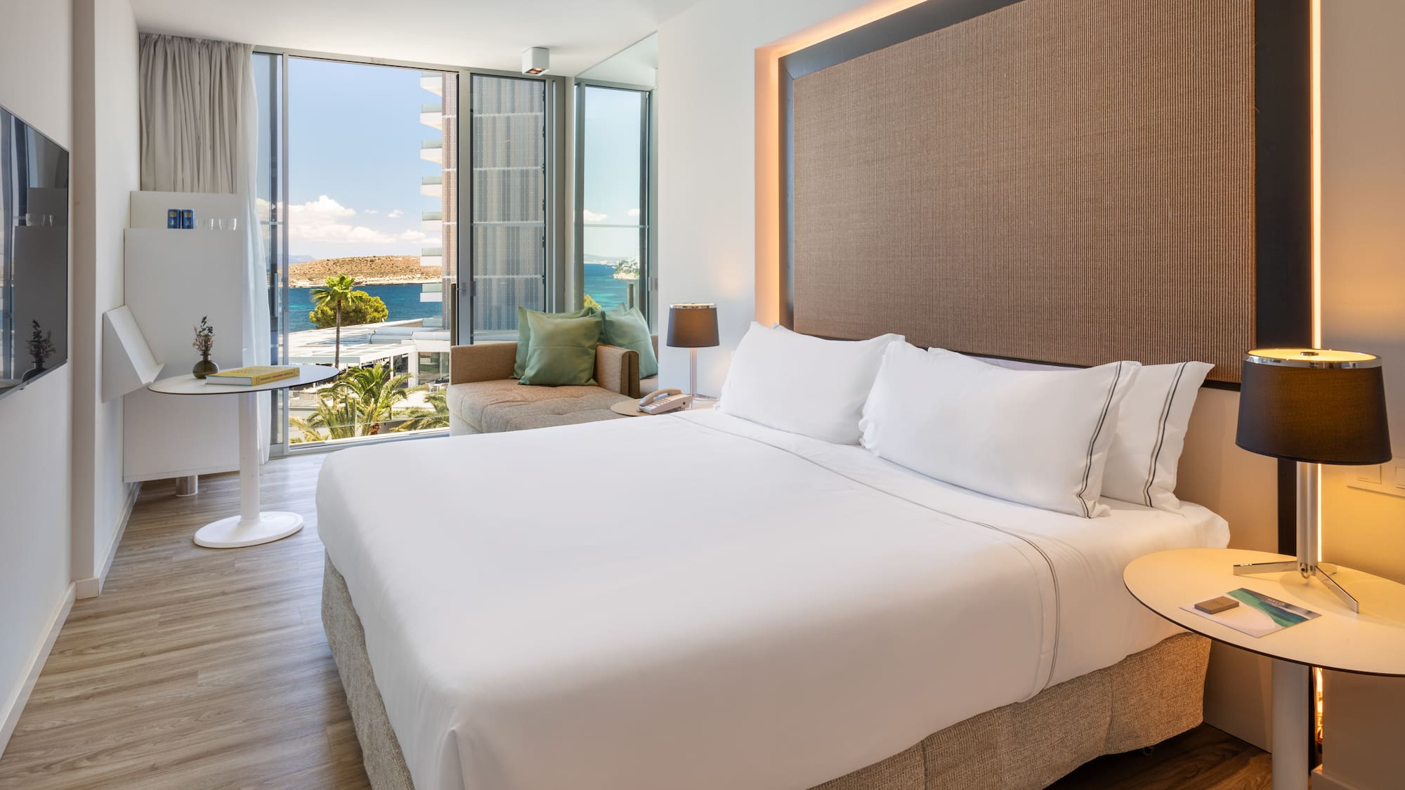 a room with a bed and a table and chairs