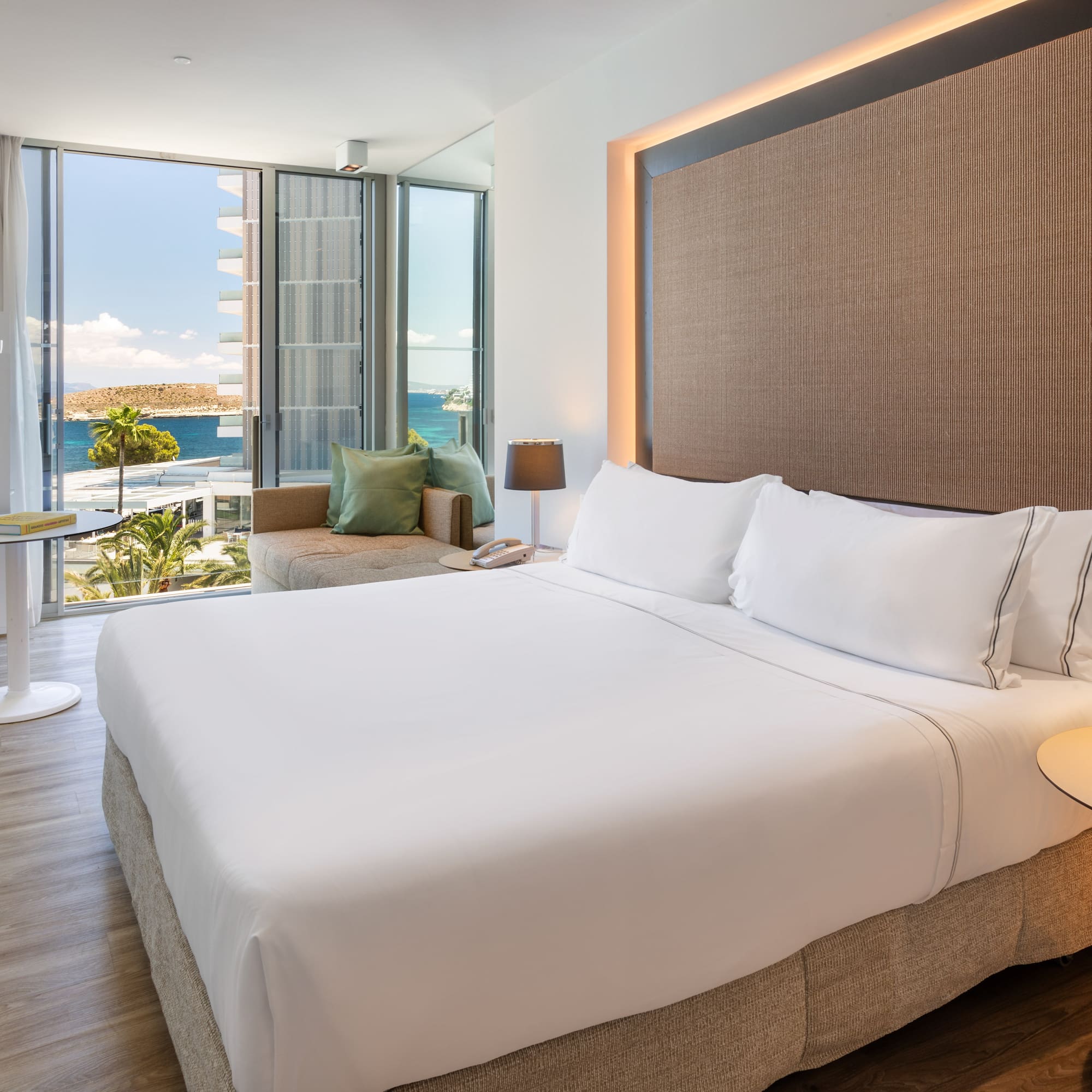 a room with a bed and a table and chairs