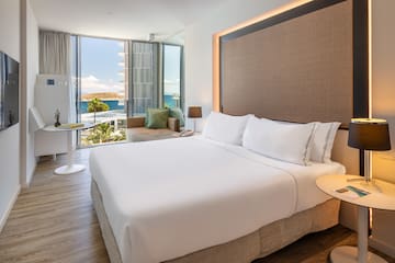 a room with a bed and a table and chairs