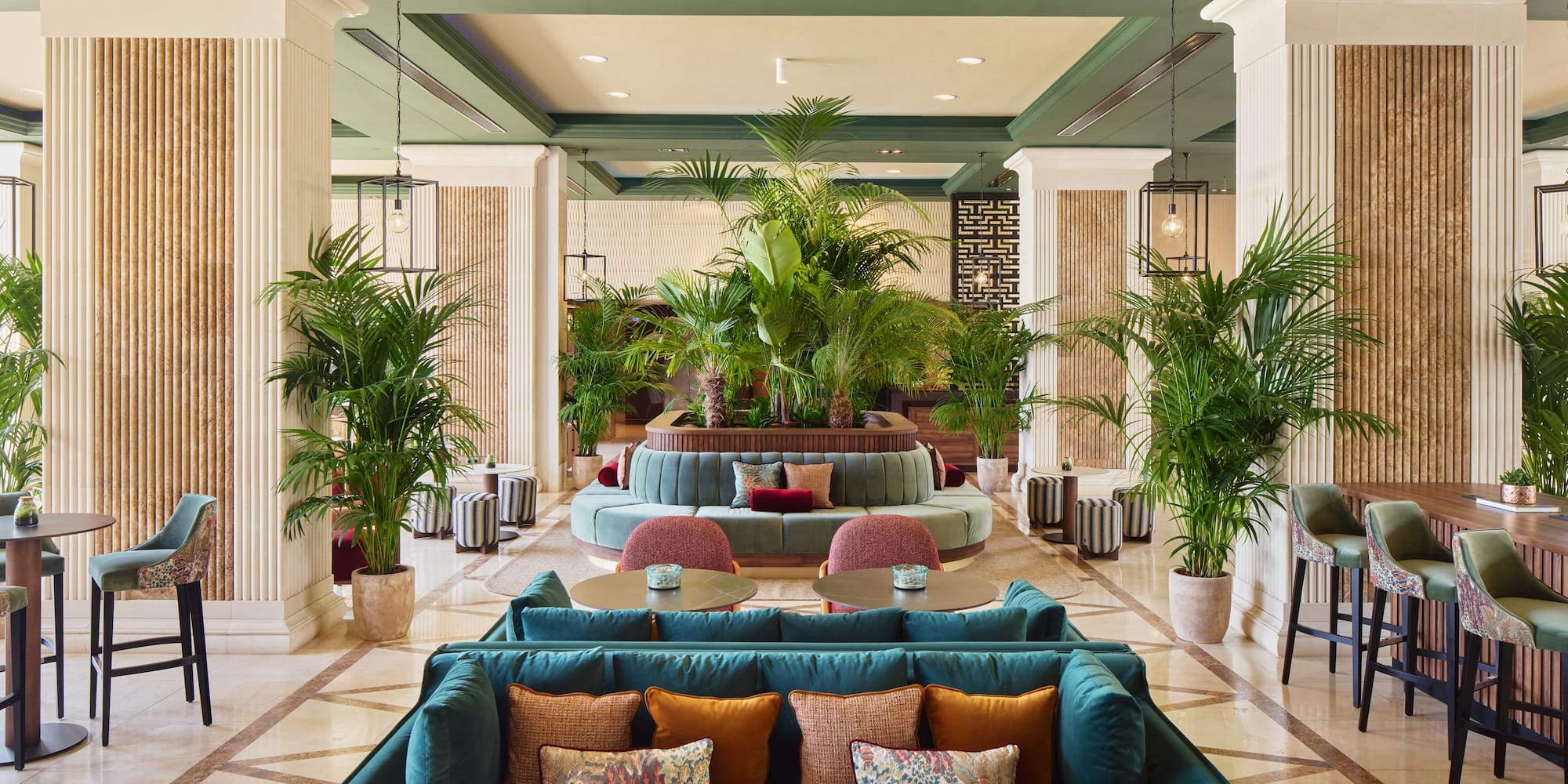 a lobby with a large round table and chairs
