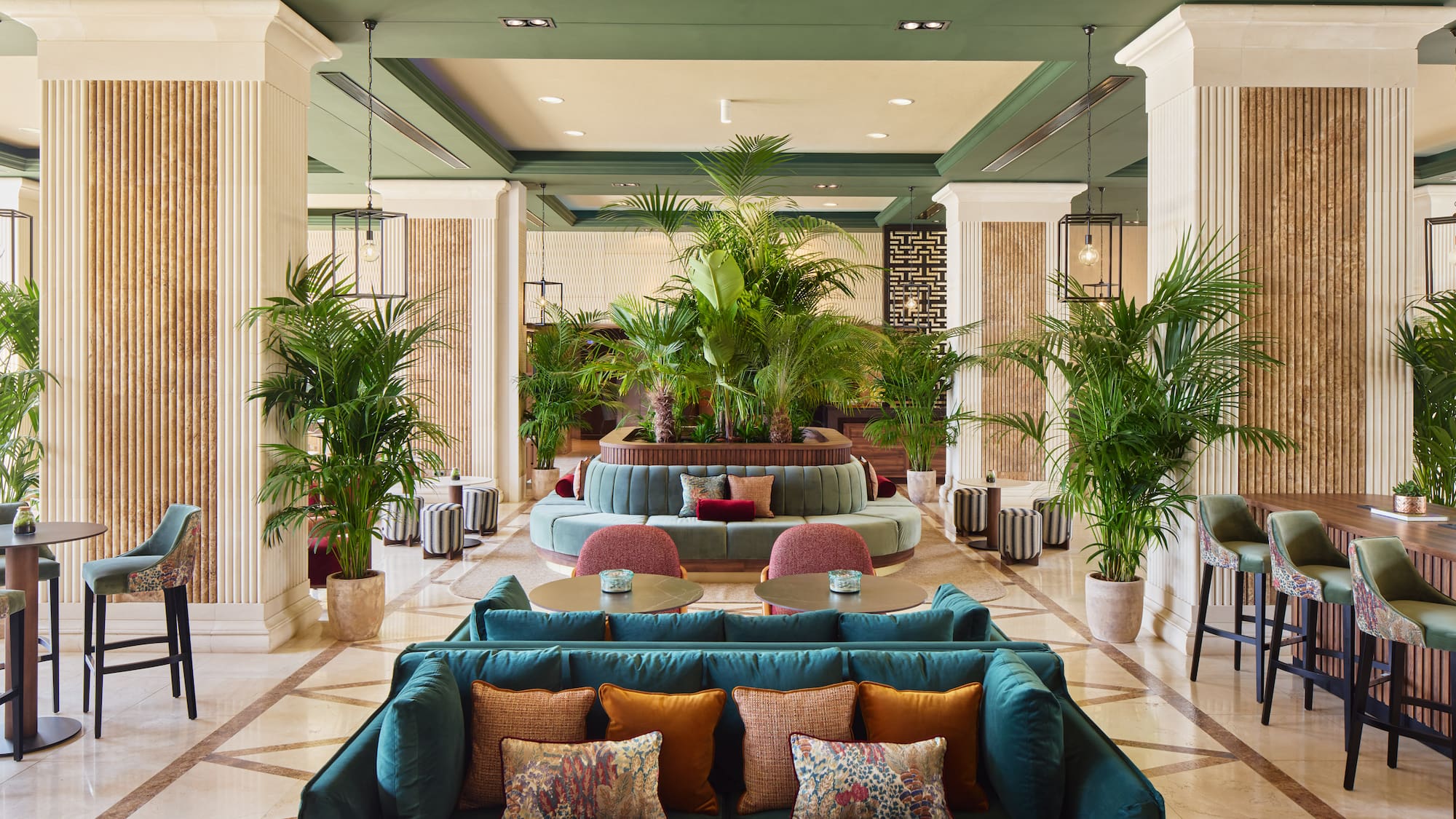 a lobby with a large round table and chairs