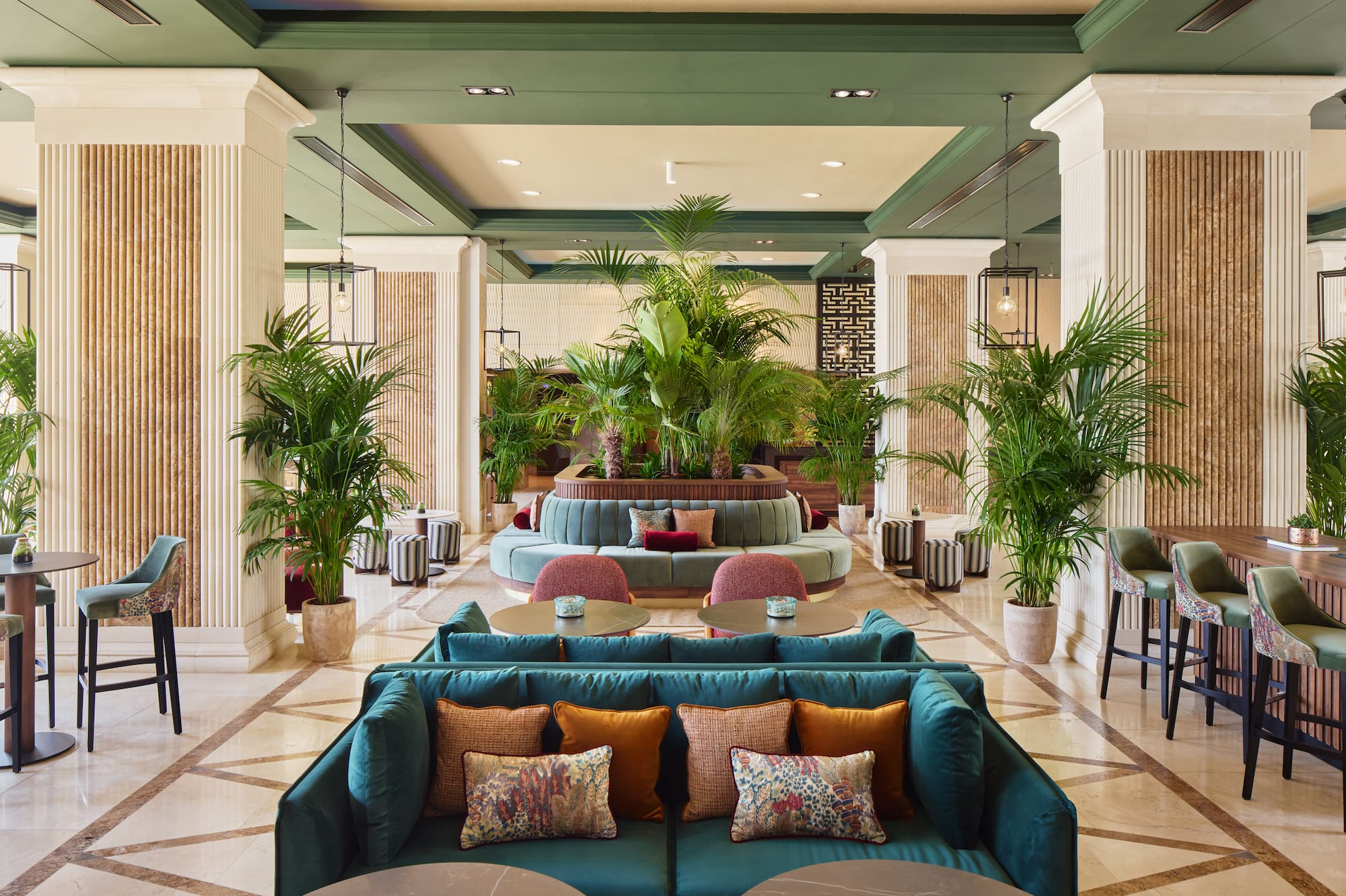 a lobby with a large round table and chairs