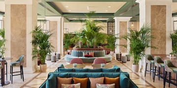 a lobby with a large round table and chairs