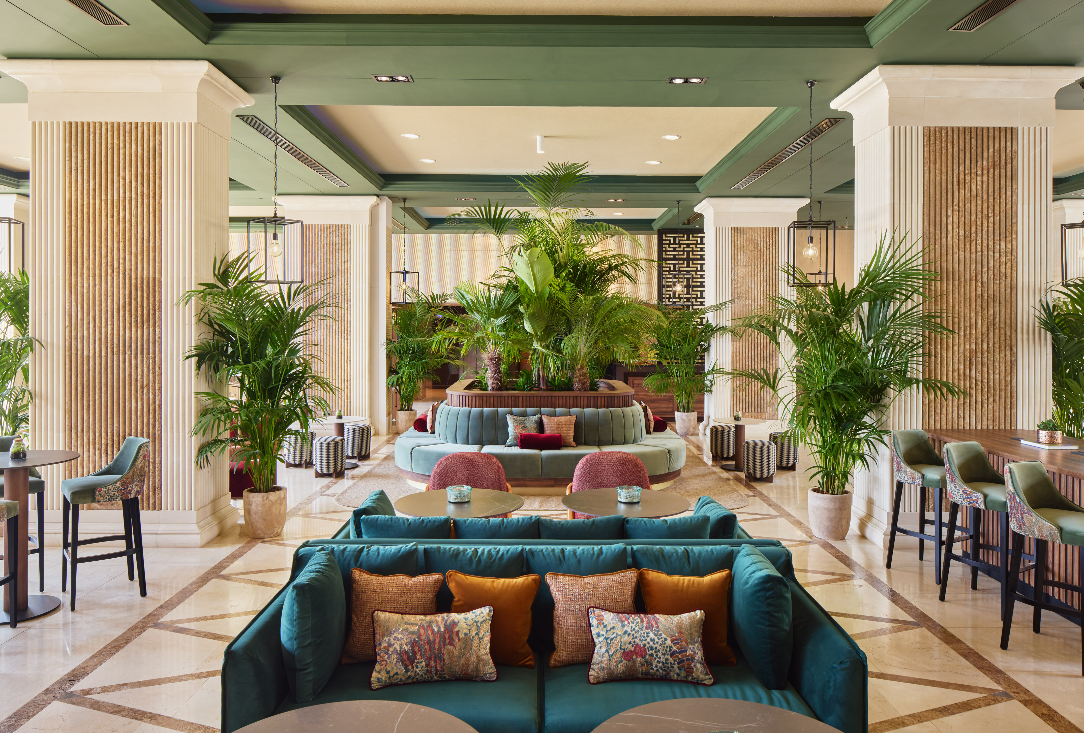 a lobby with a large round table and chairs