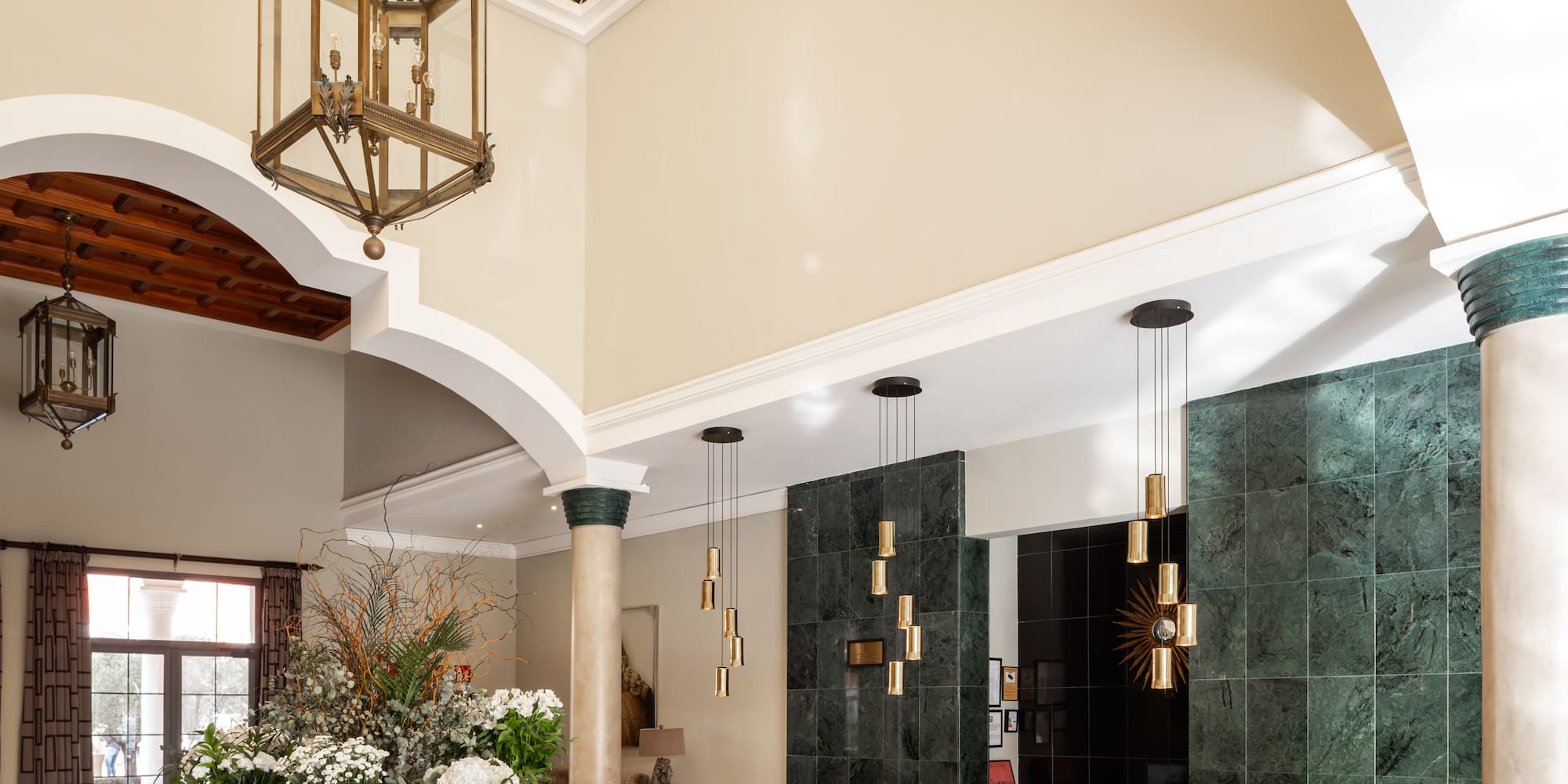 a room with a large staircase and a large glass roof