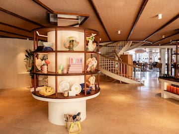 a spiral staircase with a circular shelf with objects on it