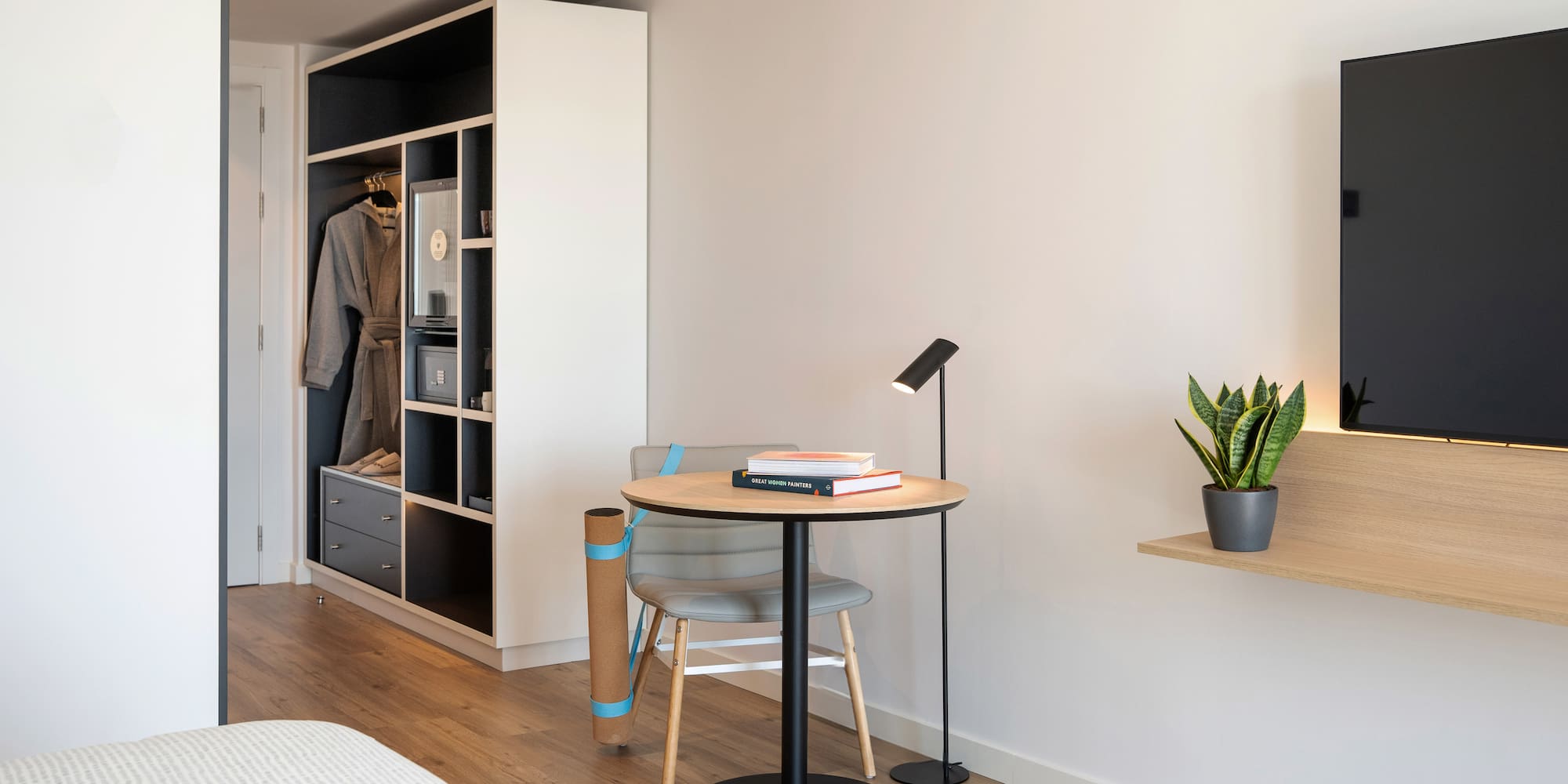 a room with a table and chair and a book shelf