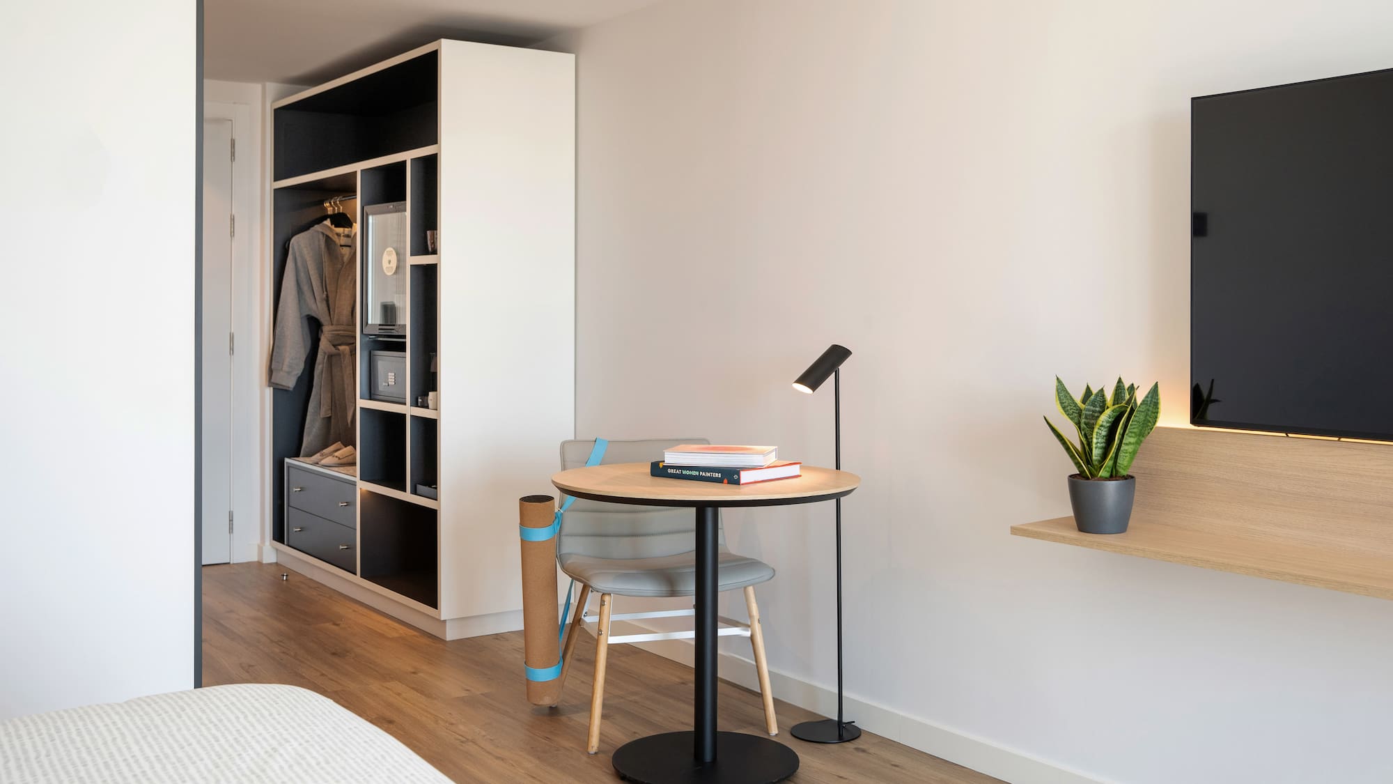 a room with a table and chair and a book shelf