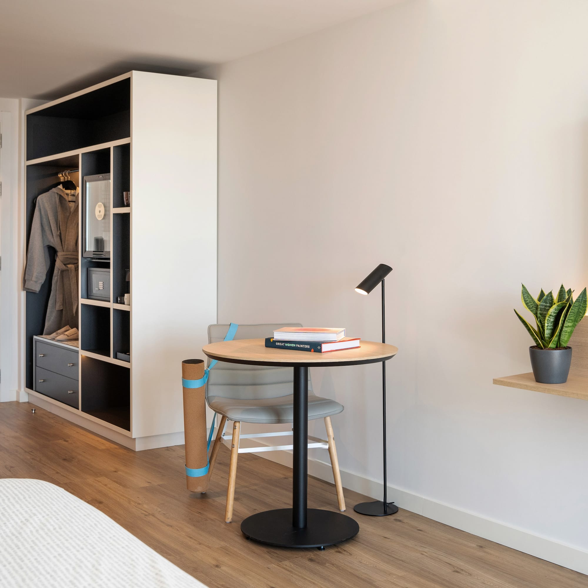 a room with a table and chair and a book shelf