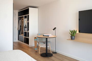 a room with a table and chair and a book shelf