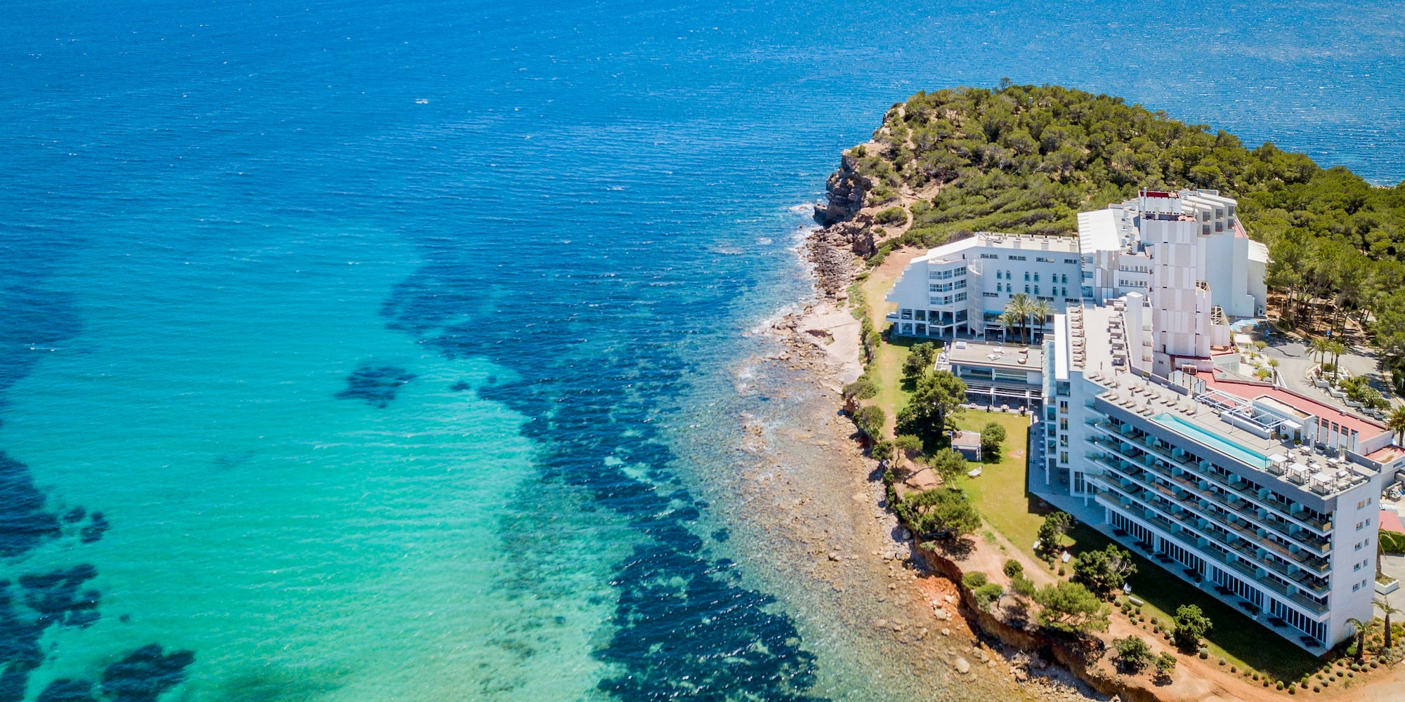 a white building next to a body of water