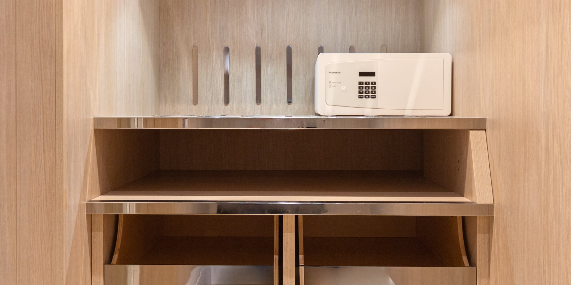 a white microwave on a shelf