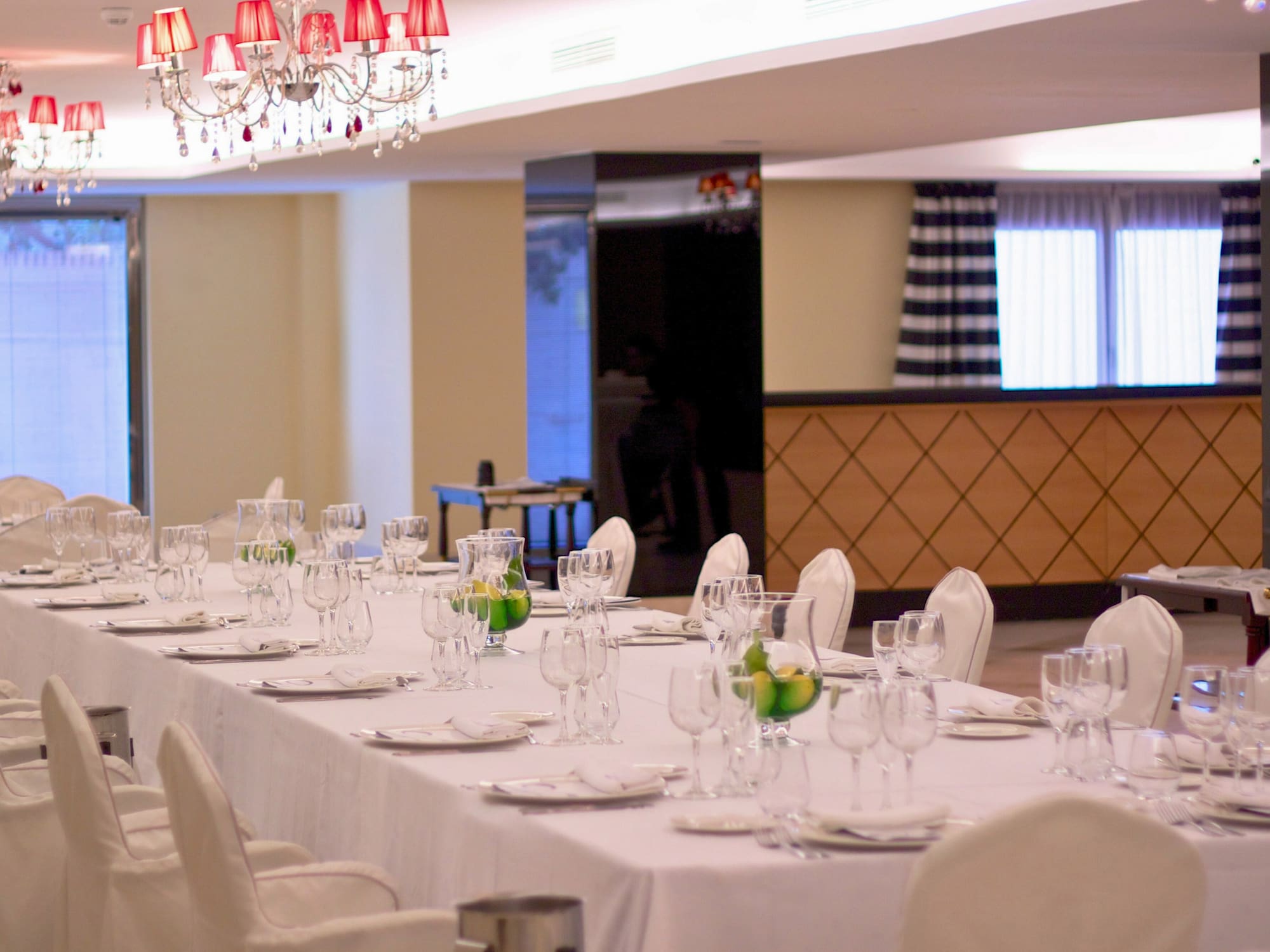 a long table with white tablecloths and glasses