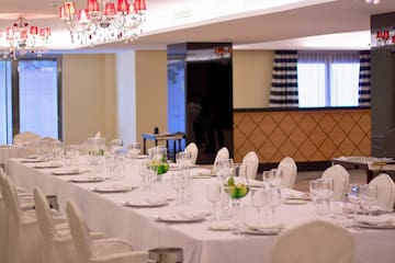 a long table with white tablecloths and glasses