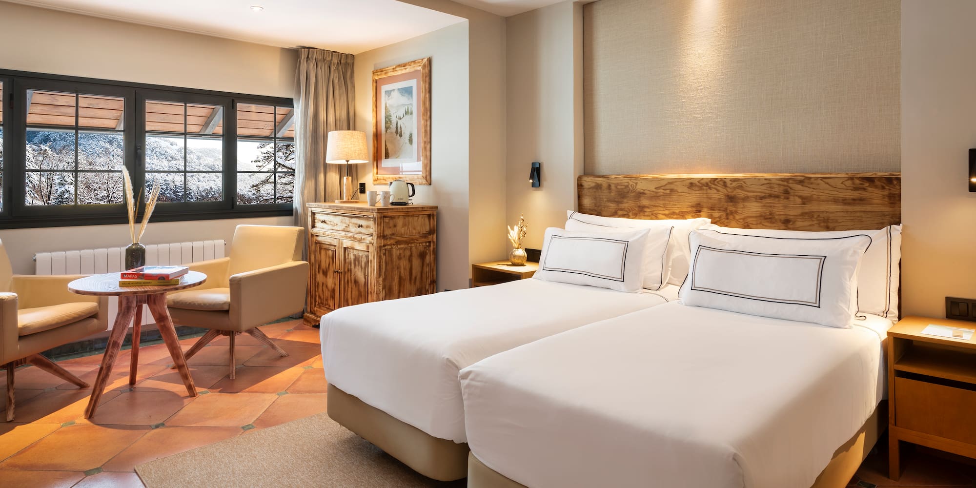 a room with two beds and a chair