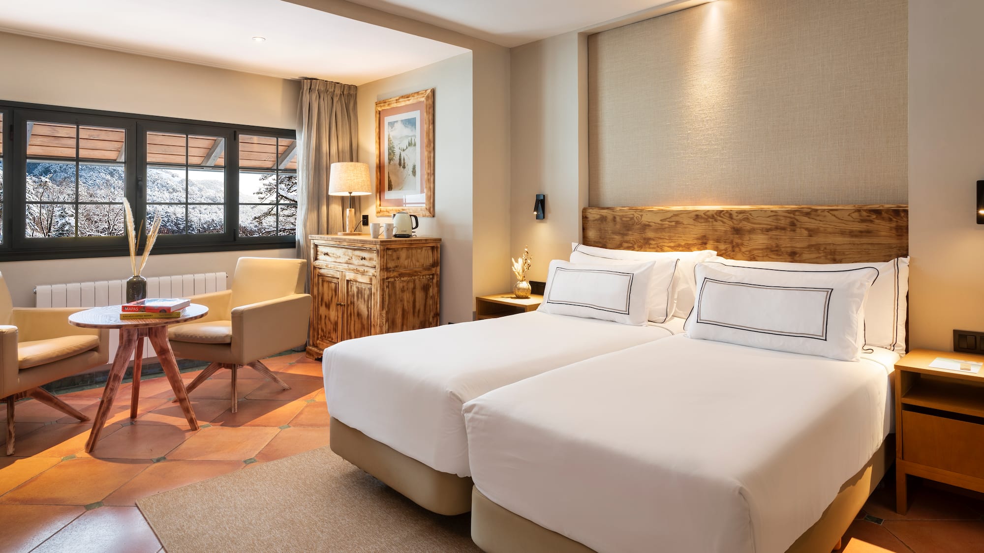 a room with two beds and a chair