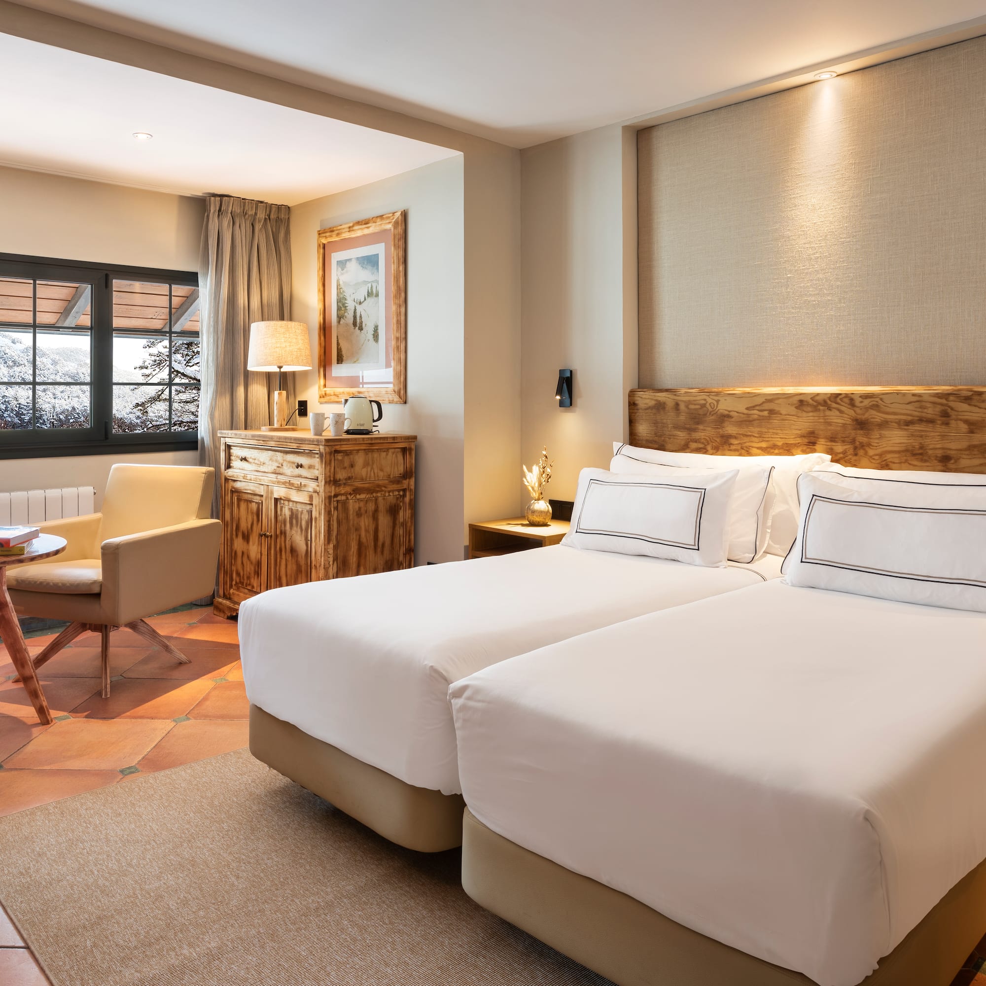 a room with two beds and a chair