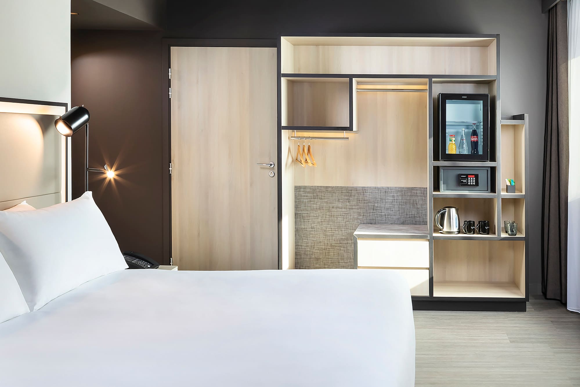 a room with a bed and a microwave