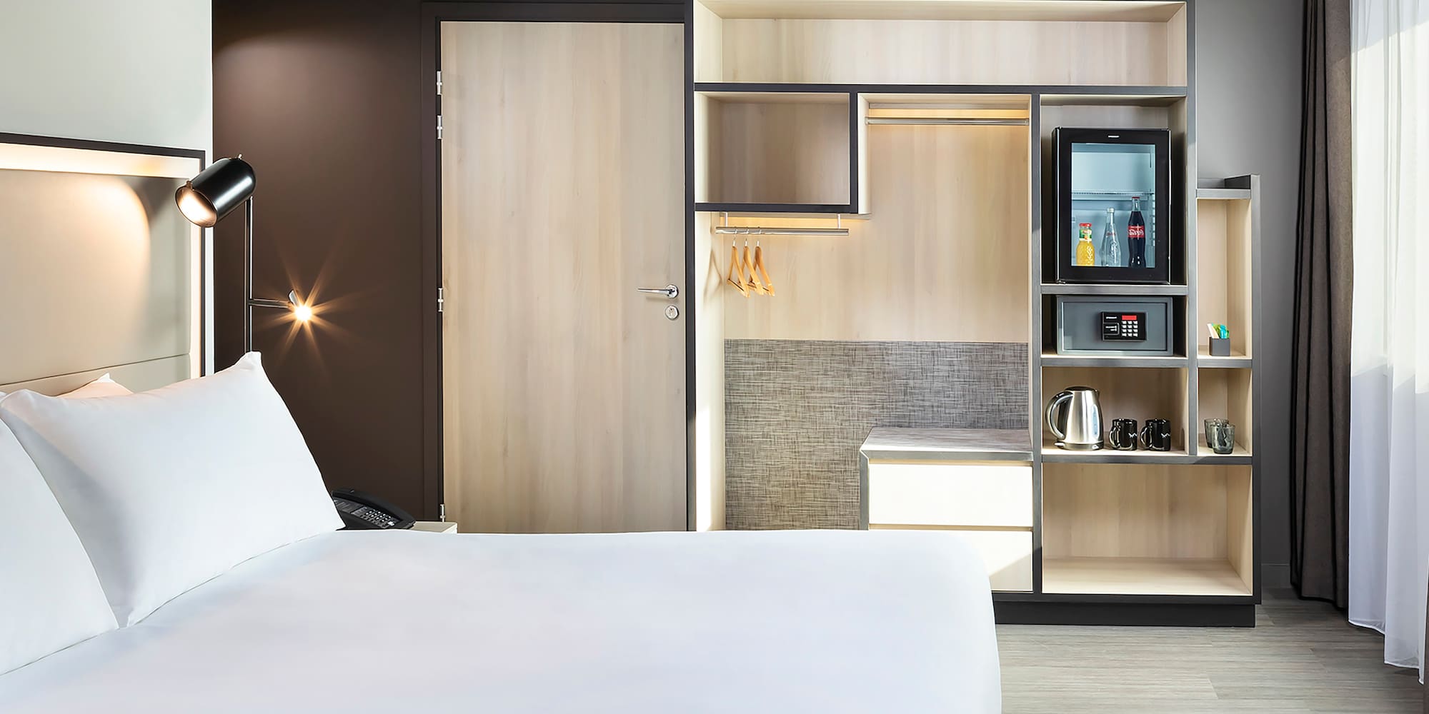 a room with a bed and a microwave