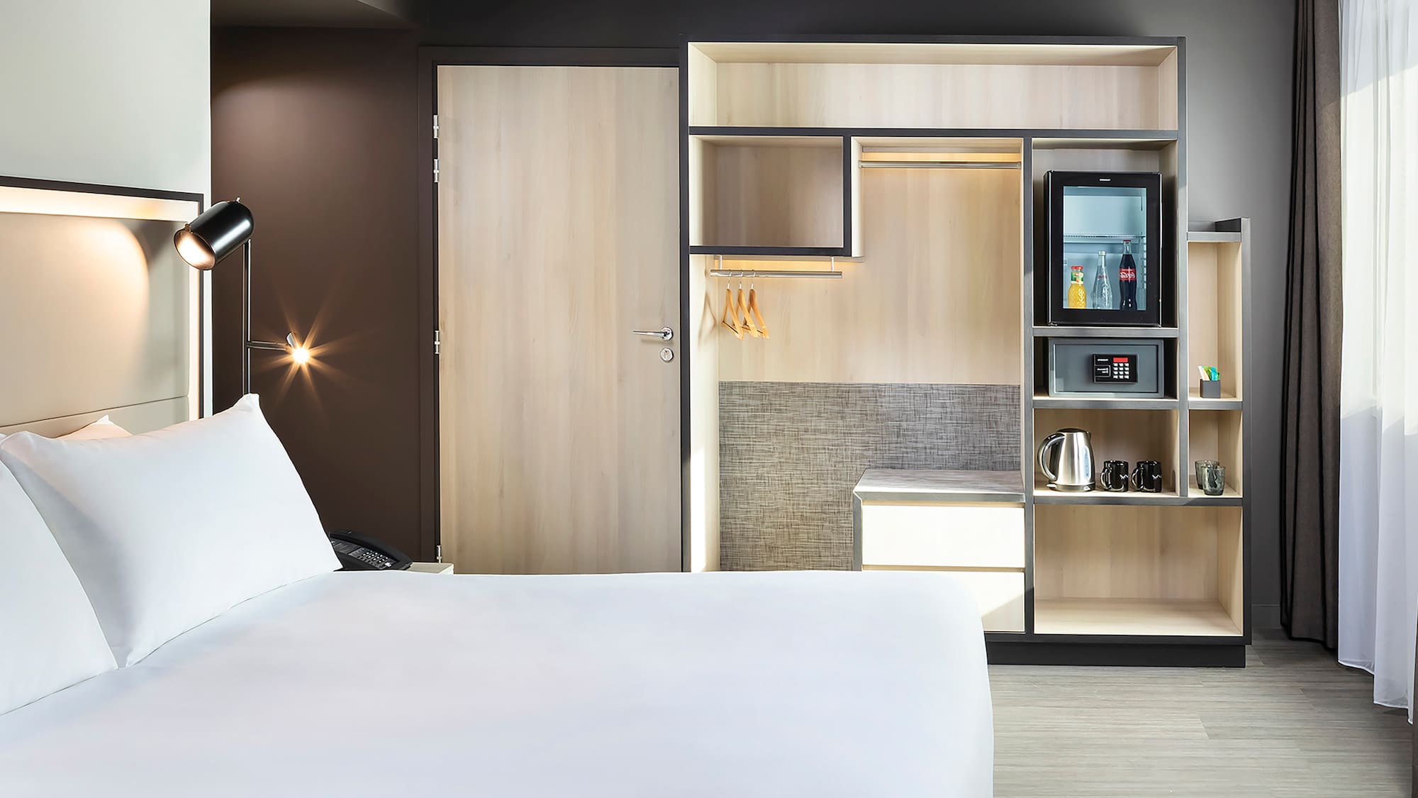 a room with a bed and a microwave