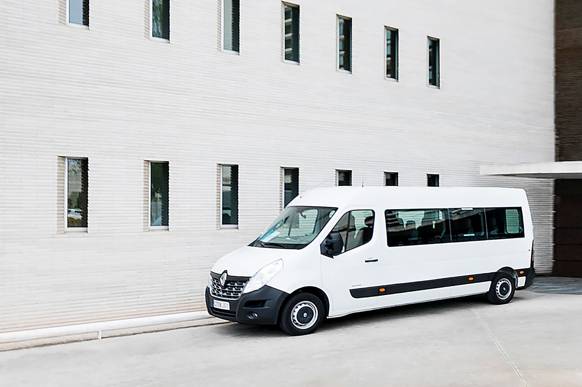 a white van parked in front of a building