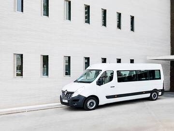 a white van parked in front of a building