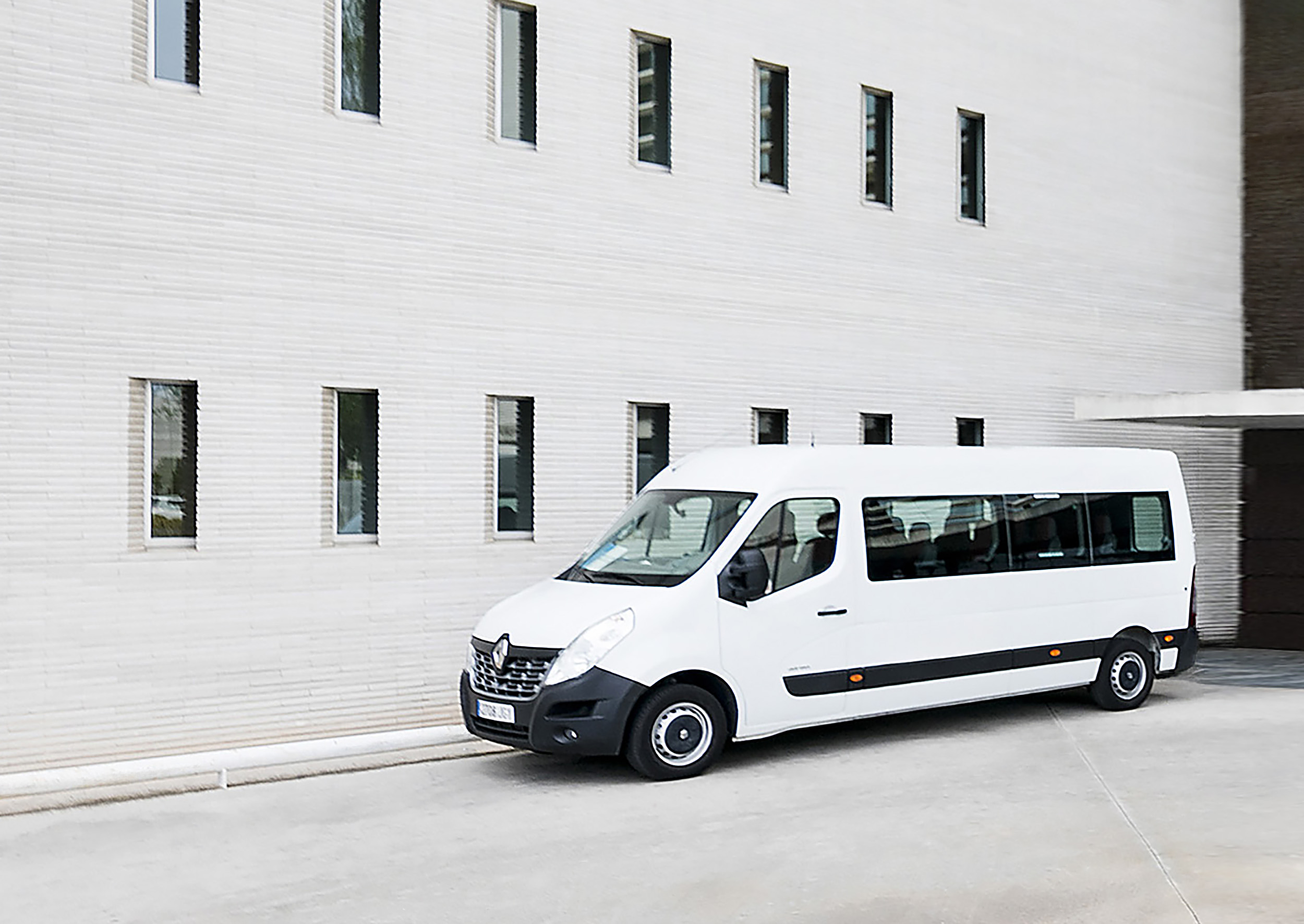 a white van parked in front of a building