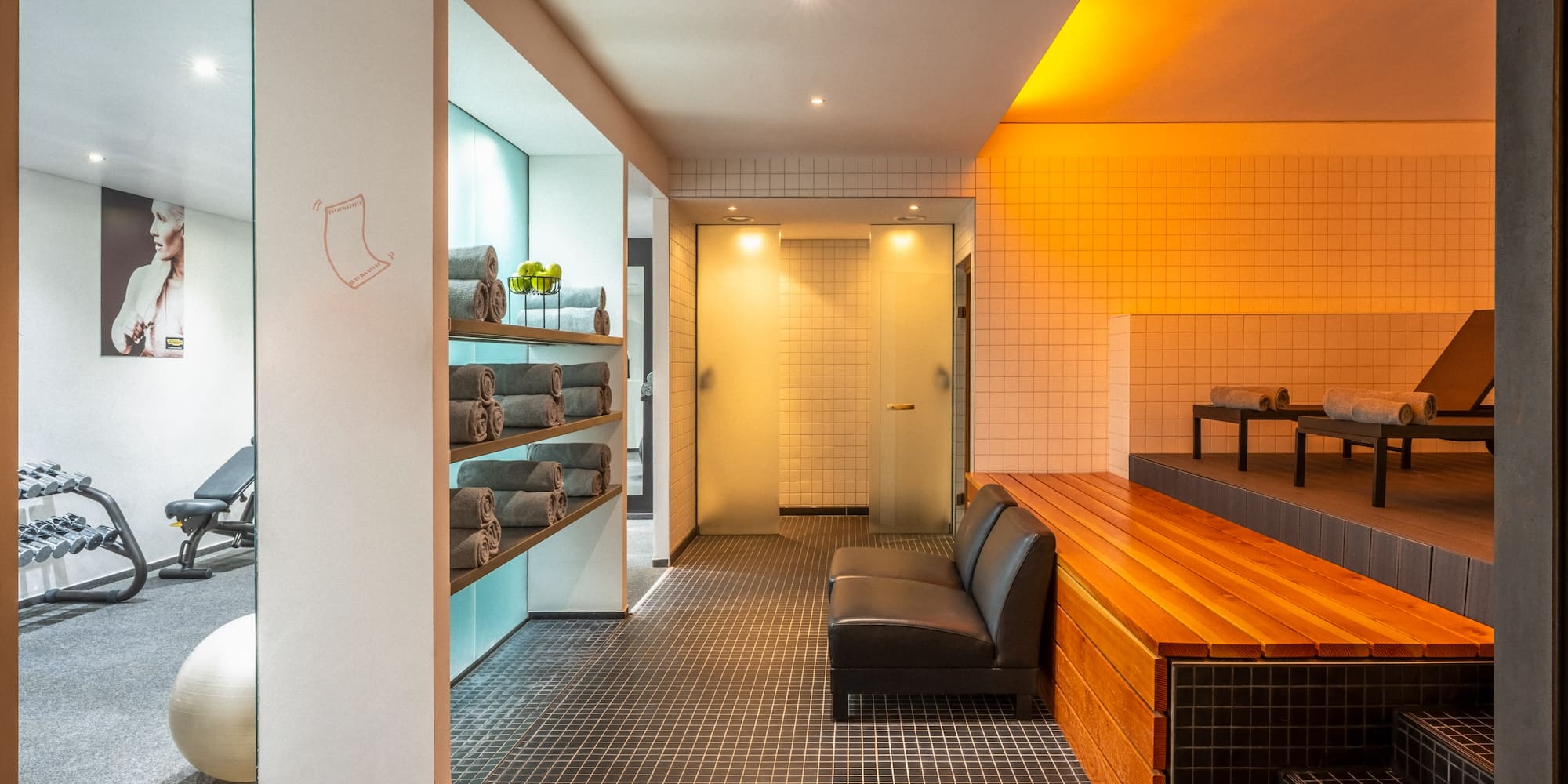 a room with a bench and towels