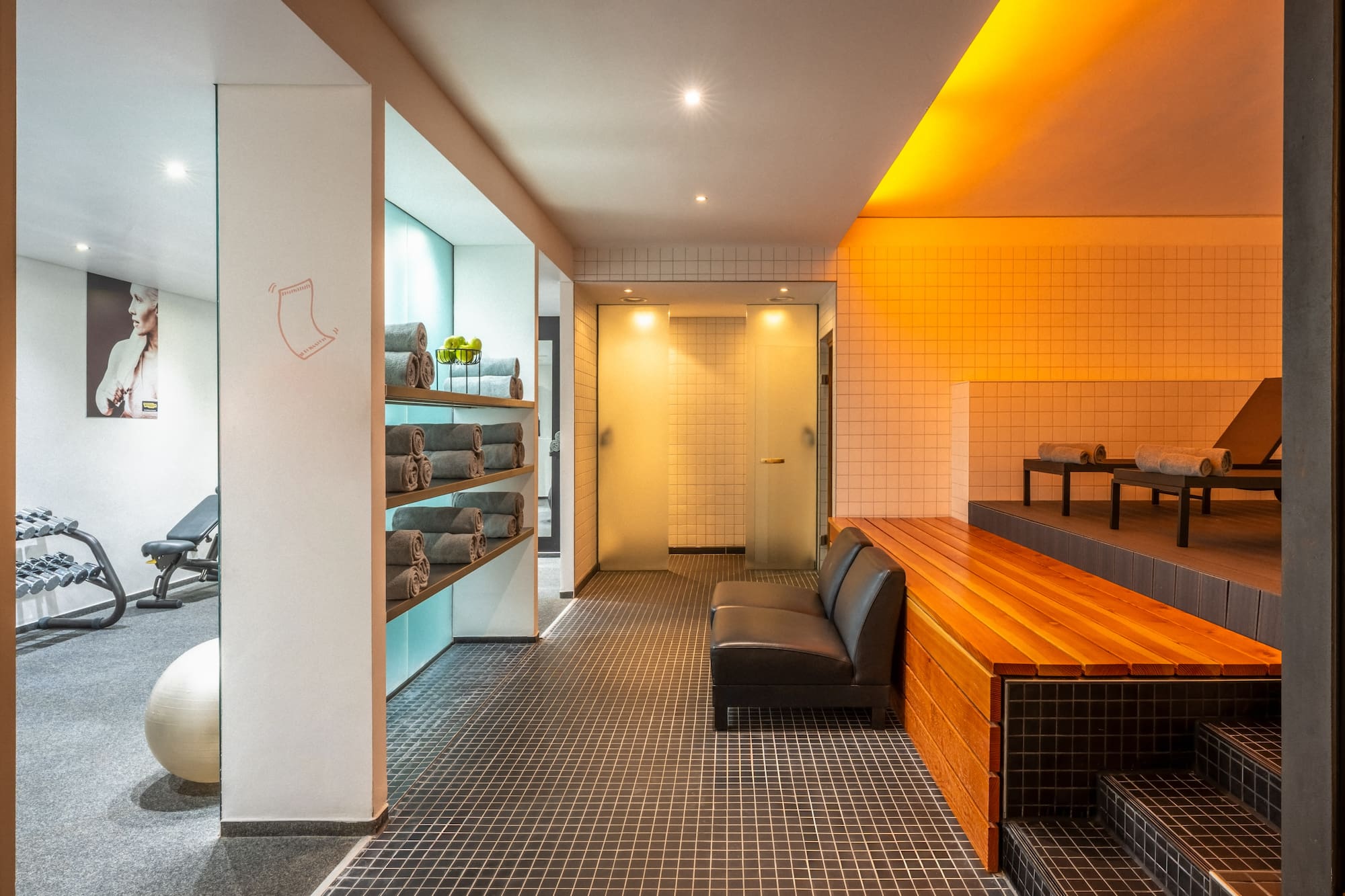 a room with a bench and towels