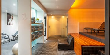 a room with a bench and towels