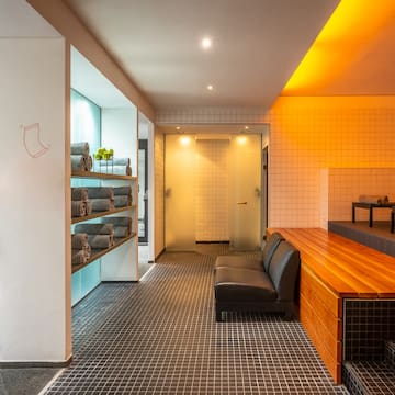 a room with a bench and towels