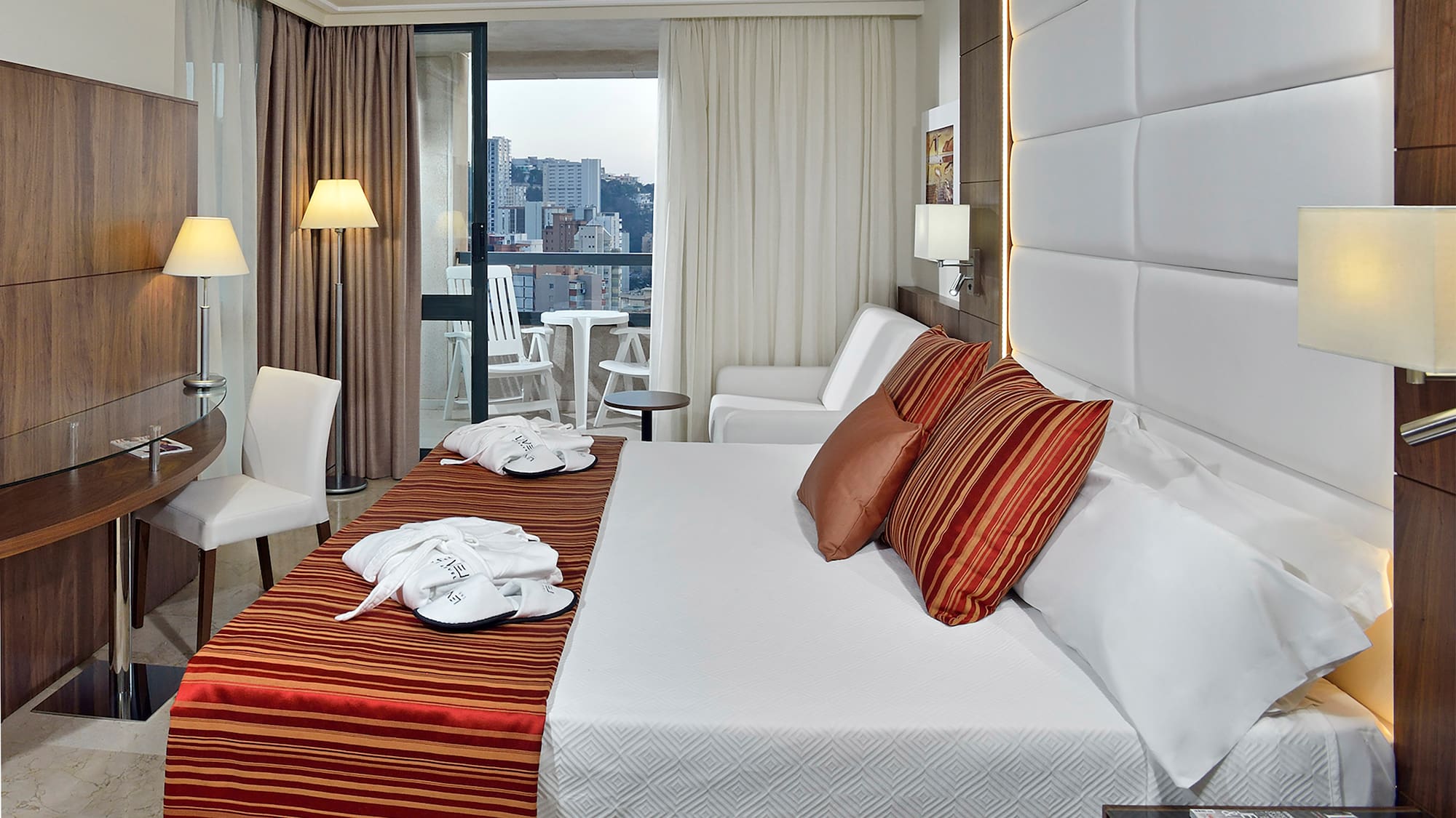 a hotel room with a bed and chairs