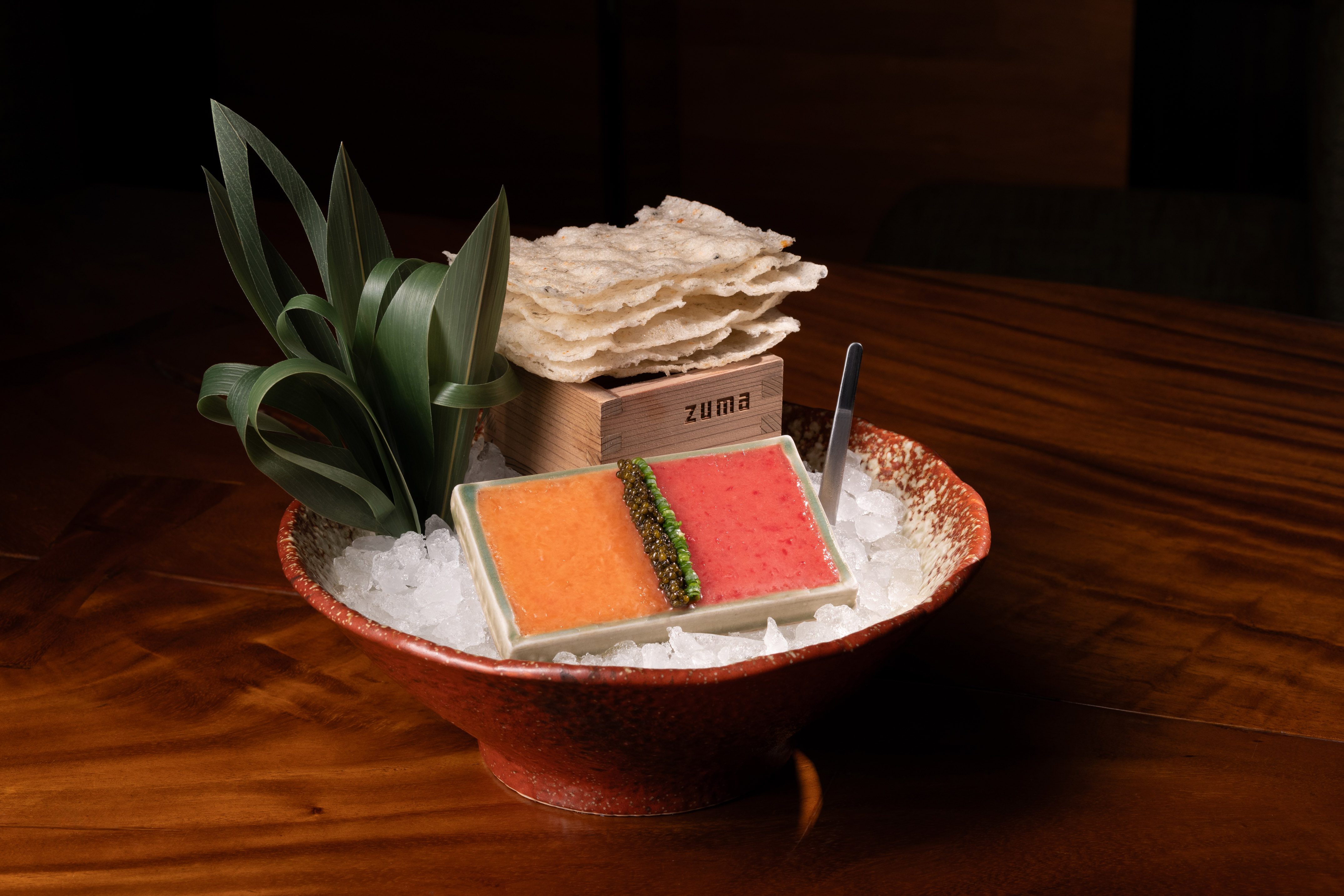 Zuma two-color seafood dish with roe, served on ice with rice crackers.