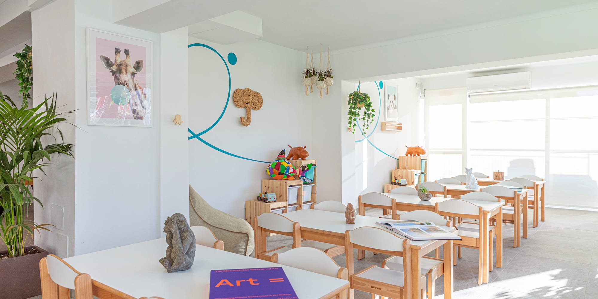 a room with white tables and chairs