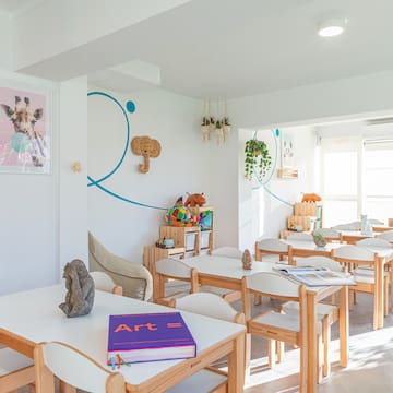 a room with white tables and chairs