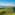 Helicopter flying over Italian vineyards, village, and historic tower.