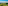 Helicopter over rolling green vineyards and hilltop village in a sunny wine region.