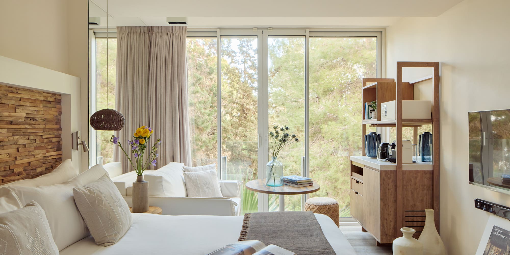 a bedroom with a bed and a table and chairs