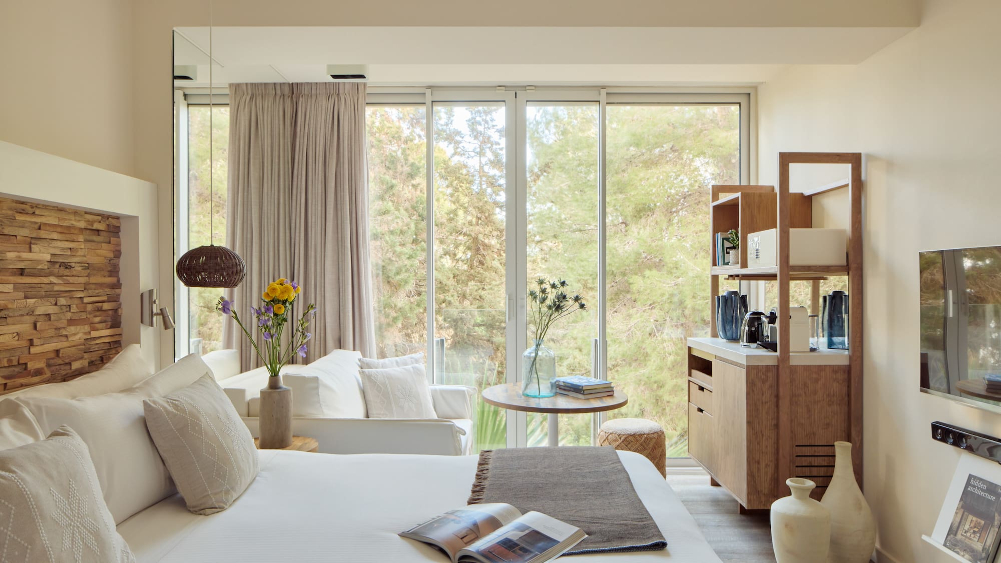 a bedroom with a bed and a table and chairs