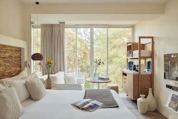 a bedroom with a bed and a table and chairs