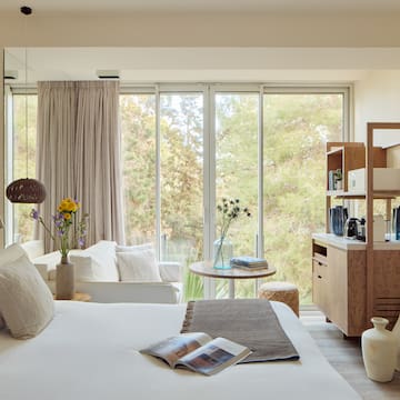 a bedroom with a bed and a table and chairs