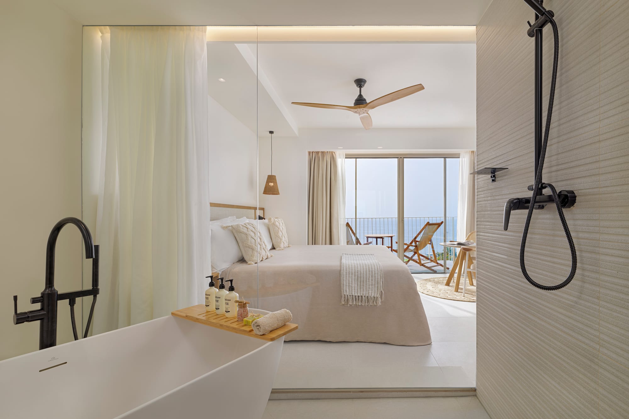 a bathroom with a bathtub and a bed