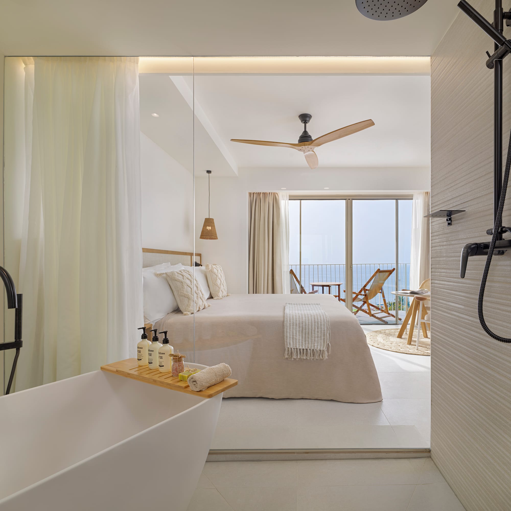 a bathroom with a bathtub and a bed