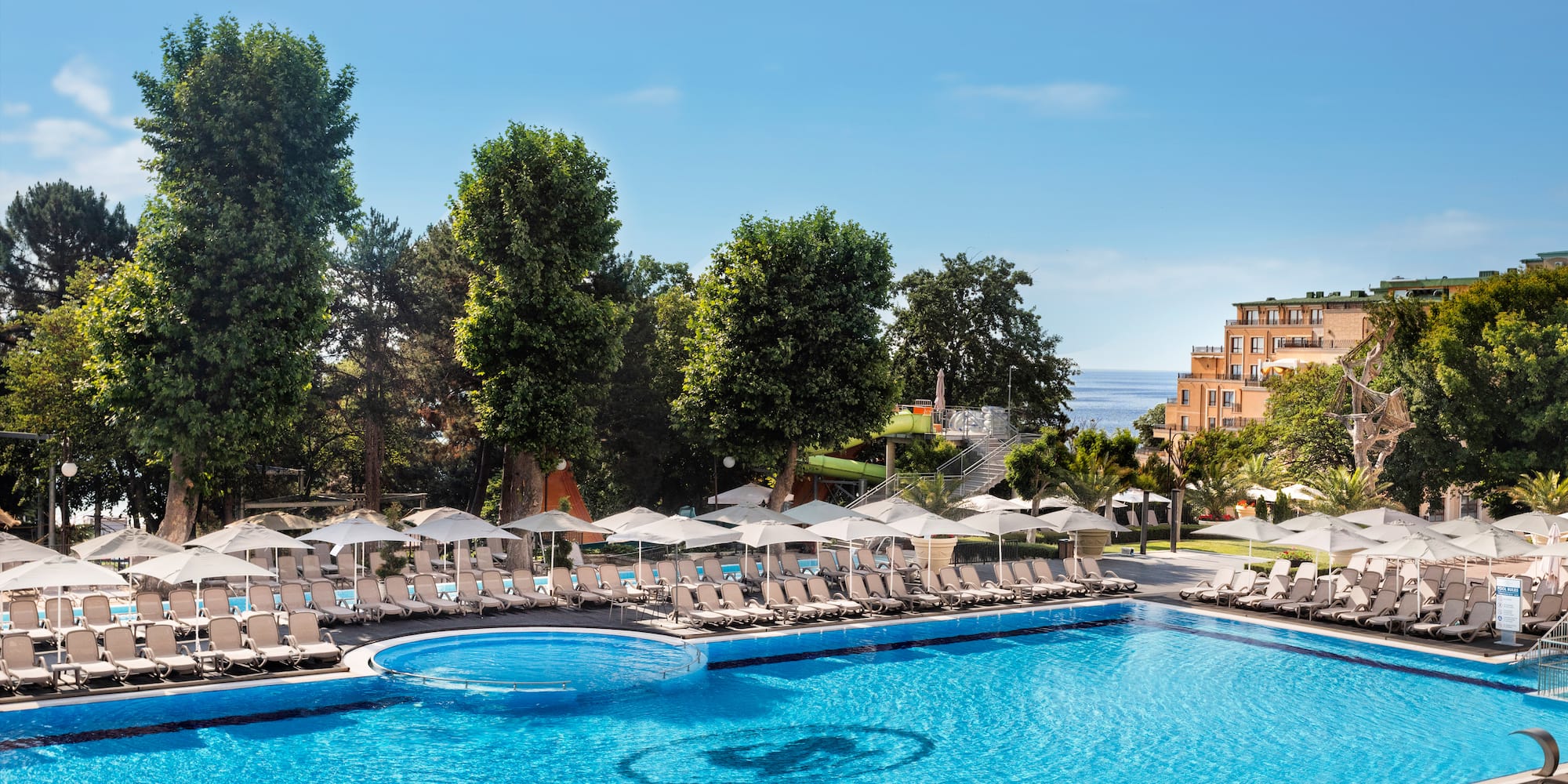 a pool with umbrellas and chairs