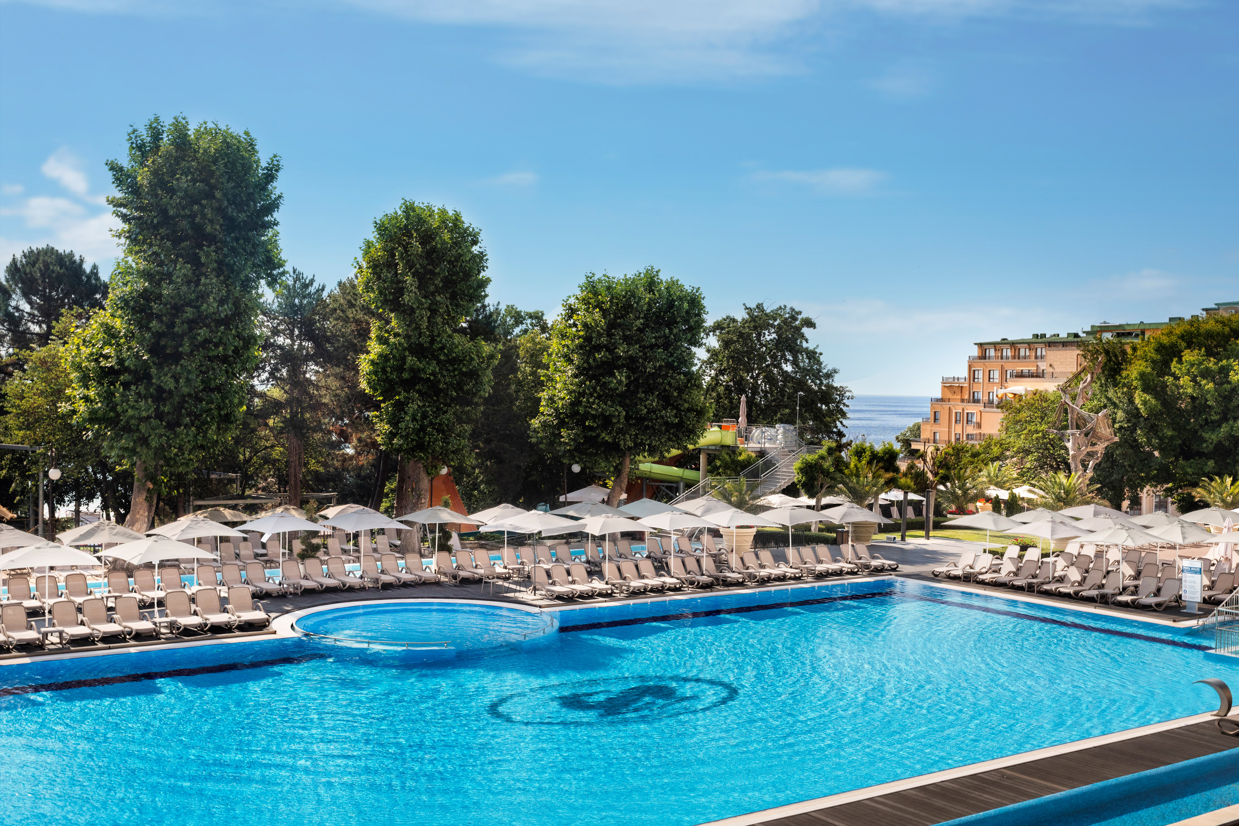a pool with umbrellas and chairs