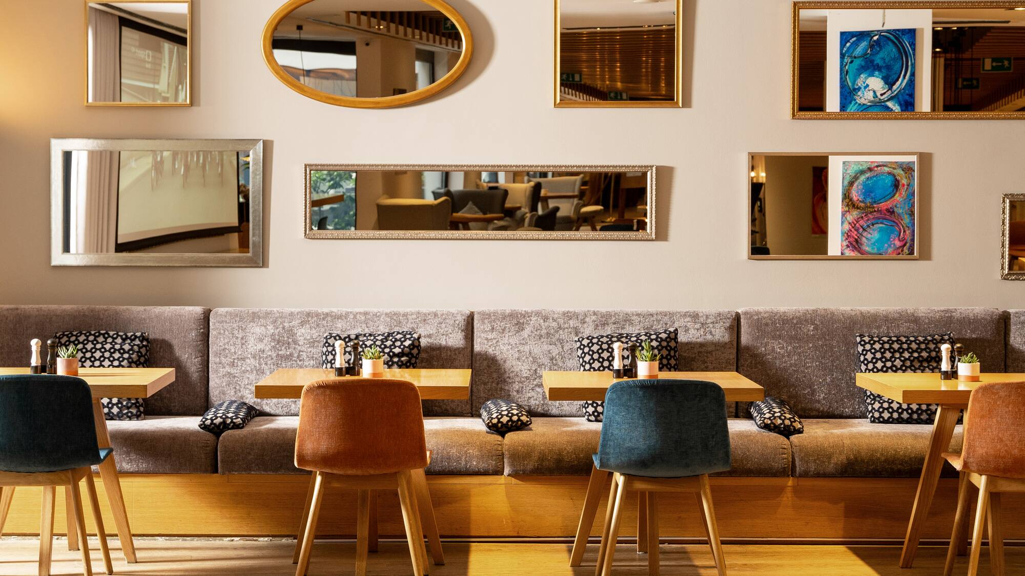 a room with a booth and tables