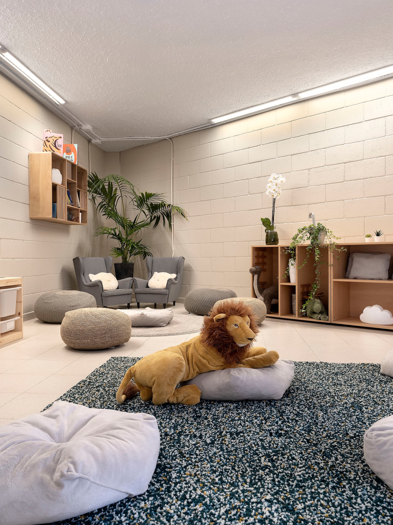 a room with a stuffed lion and pillows