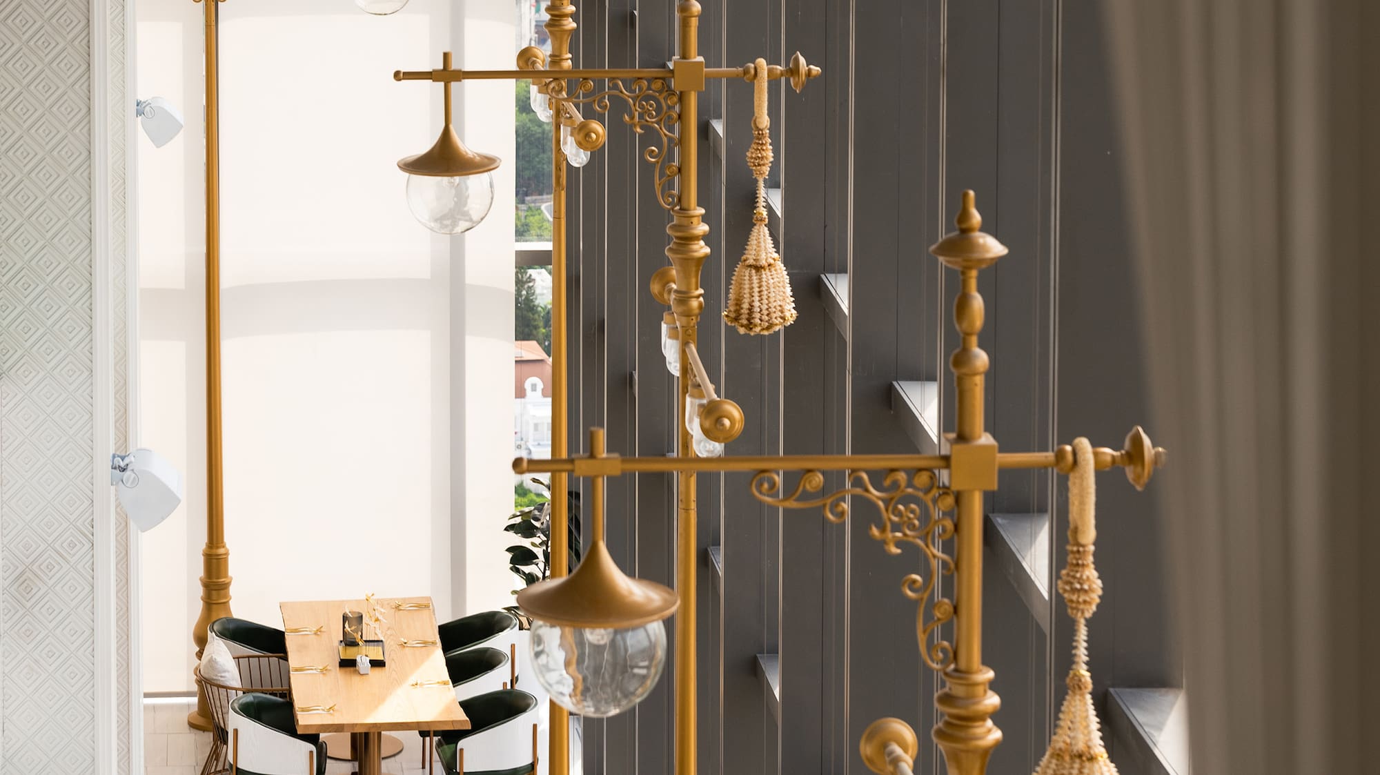 a room with a tall lamp post and tables