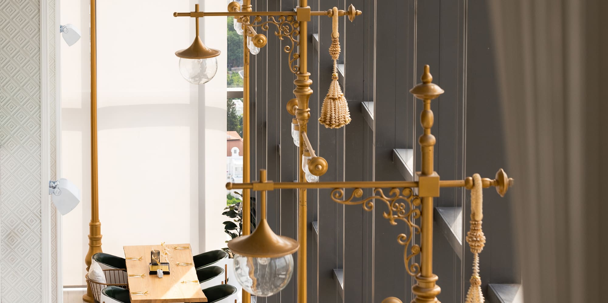 a room with a tall lamp post and tables